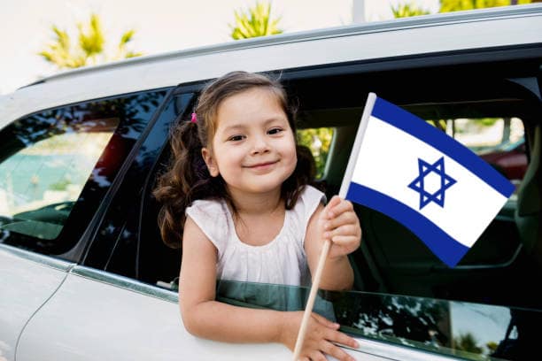 Smiling girl holding an Israeli flag