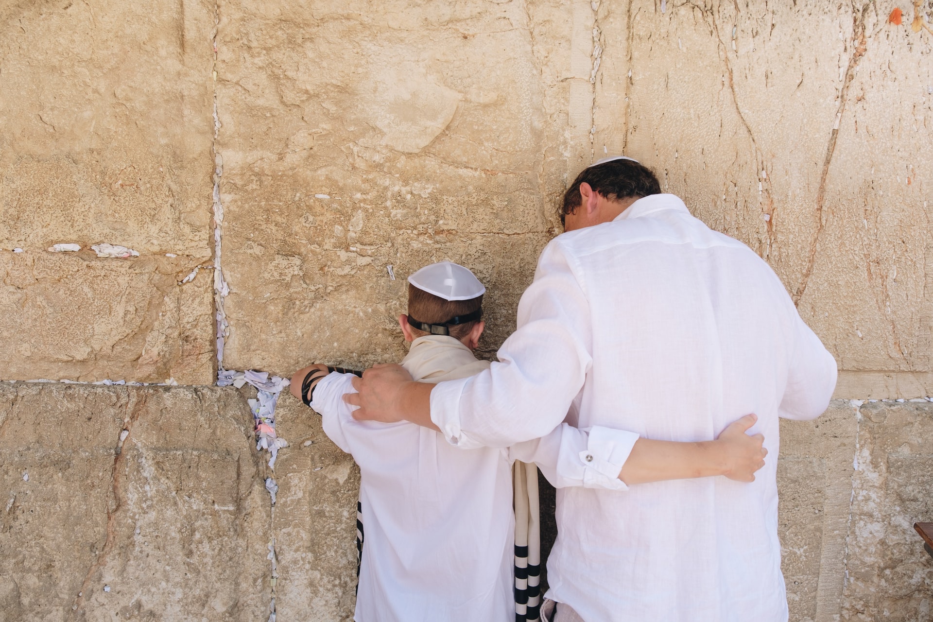 Father and son praying at the Western Wall